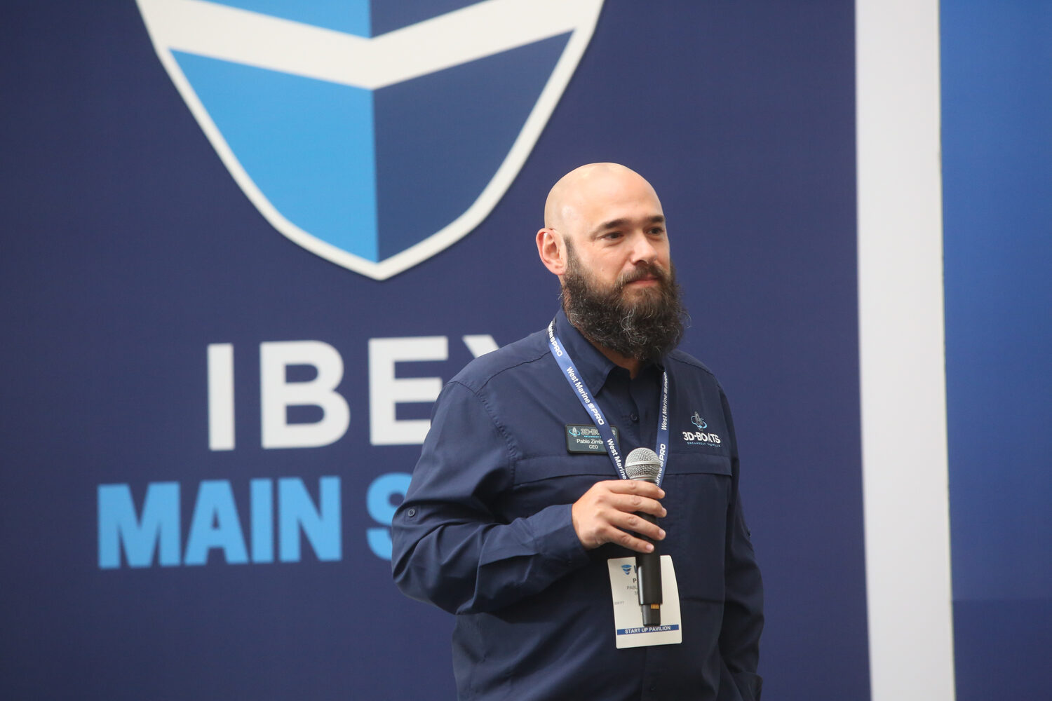 A speaker on the IBEX main stage